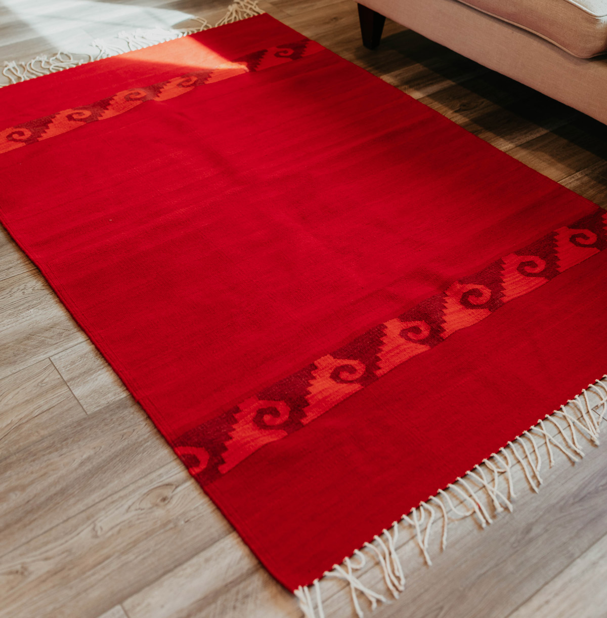 Red rug with wave pattern made in Oaxaca, Mexico