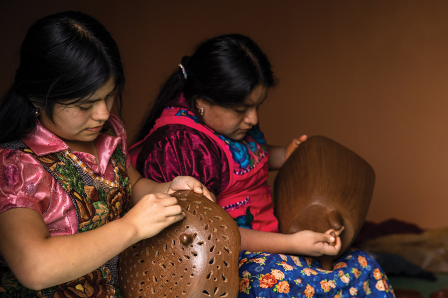 Two women working on a traditional craft from Oaxaca, Mexico