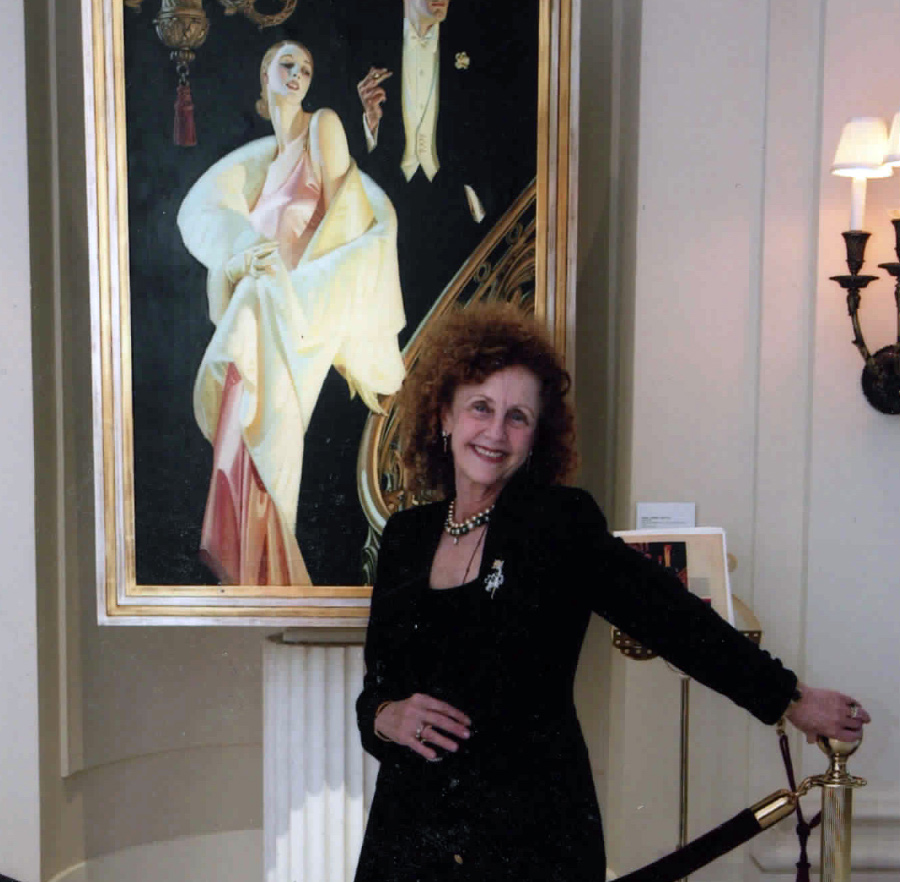 Judy Goffman Cutler, CW’63, GED’64, smiling in front of a J.C. Leyendecker illustration