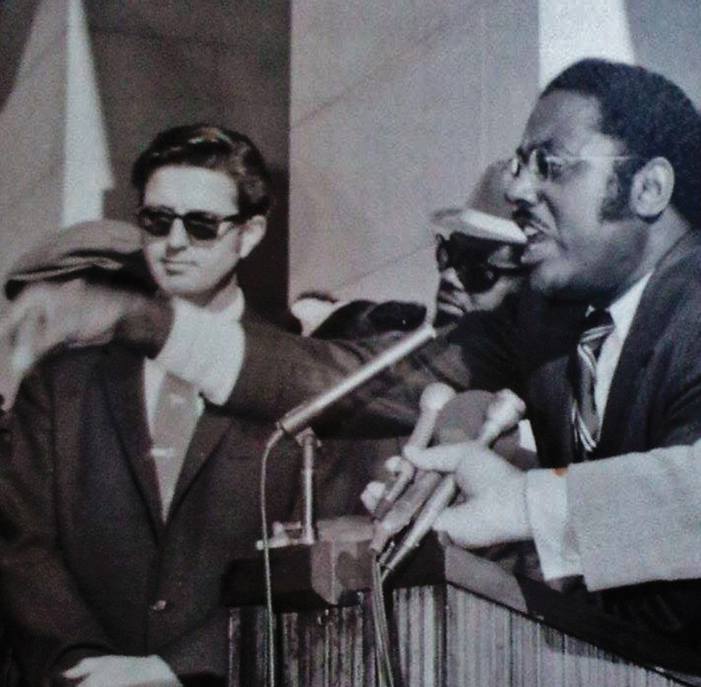 old photograph of Marcus Foster giving a passionate speech at a podium