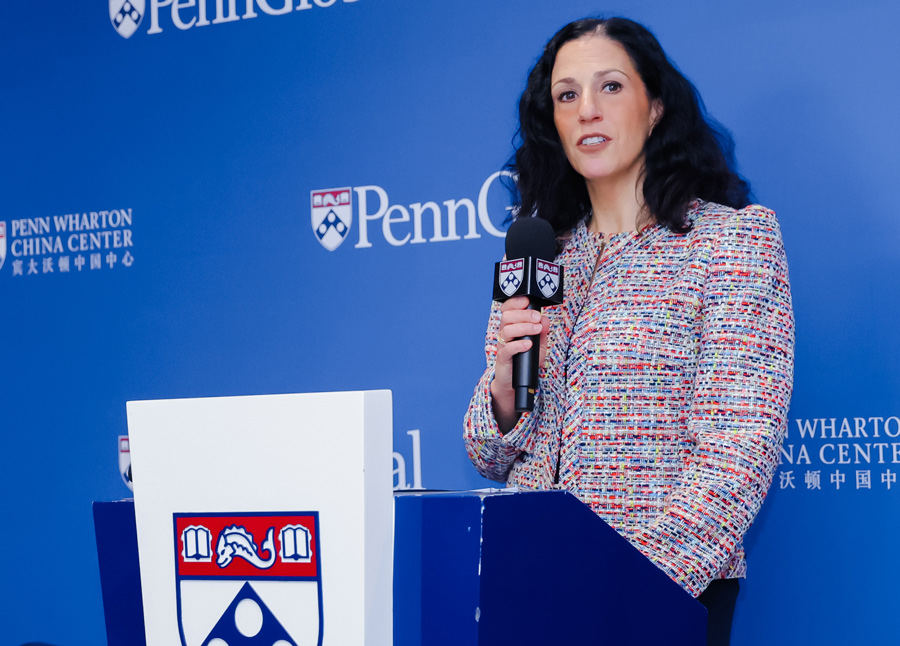 Dean Katharine O Strunk speaking at a podium with a microphone in her hand 