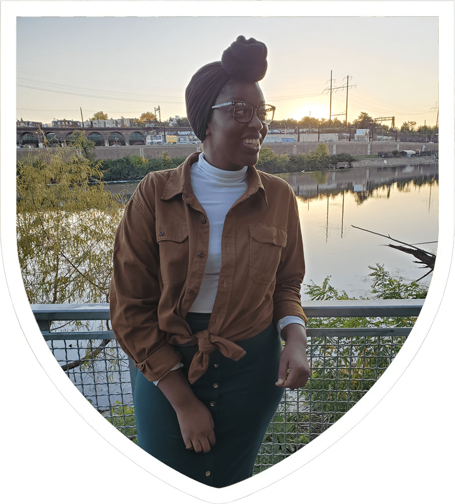Sharee DeVose smiling in front of rail overseeing water